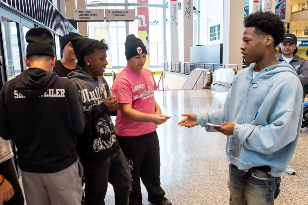 A fighter hands out passes to Hockey in New Jersey players at the Matchroom Boxing press conference at Prudential Center