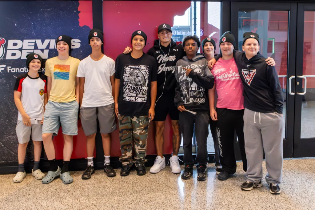 Hockey in New Jersey players pose with a fighter outside the Devils Den at the Matchroom Boxing press conference at Prudential Center