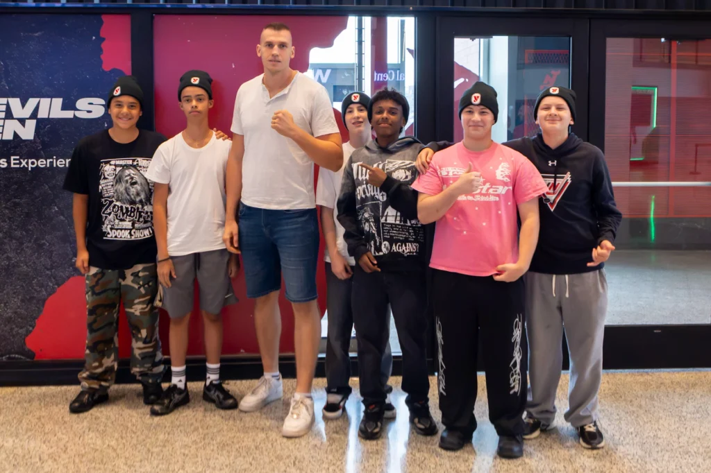 Hockey in New Jersey players pose with a heavyweight fighter at the Matchroom Boxing press conference at Prudential Center