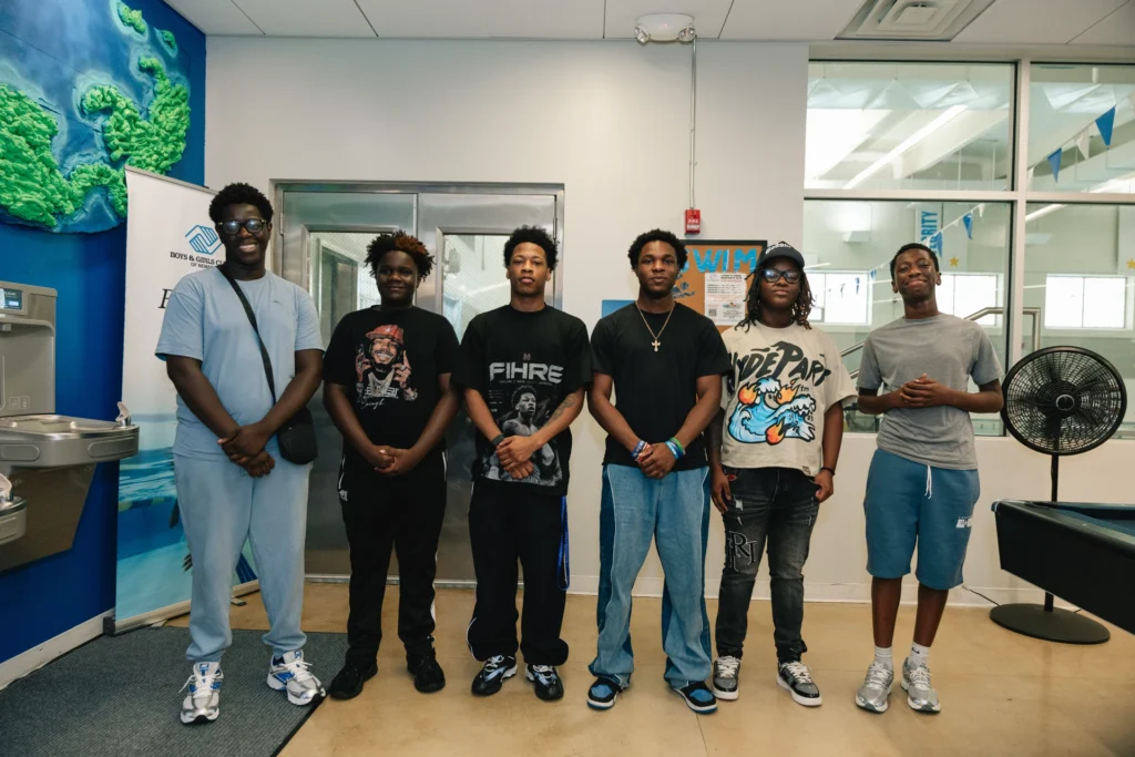 Club members pose for a group photo during Zaquin Moses's visit to the Boys & Girls Club of Newark
