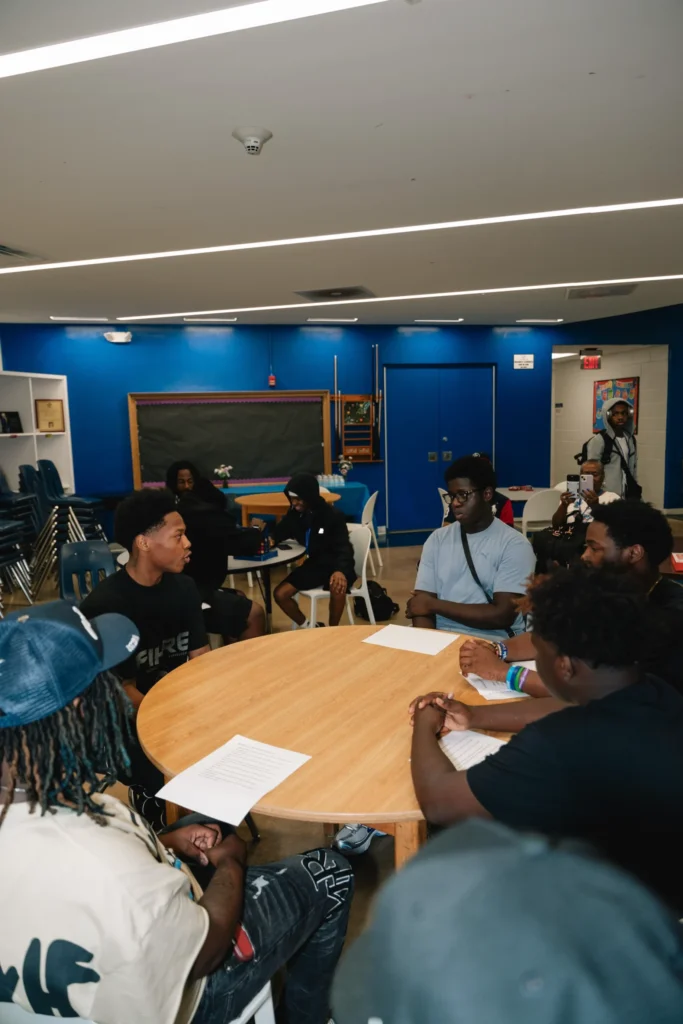 Club members sit down for a conversation during Zaquin Moses's visit to the Boys & Girls Club of Newark